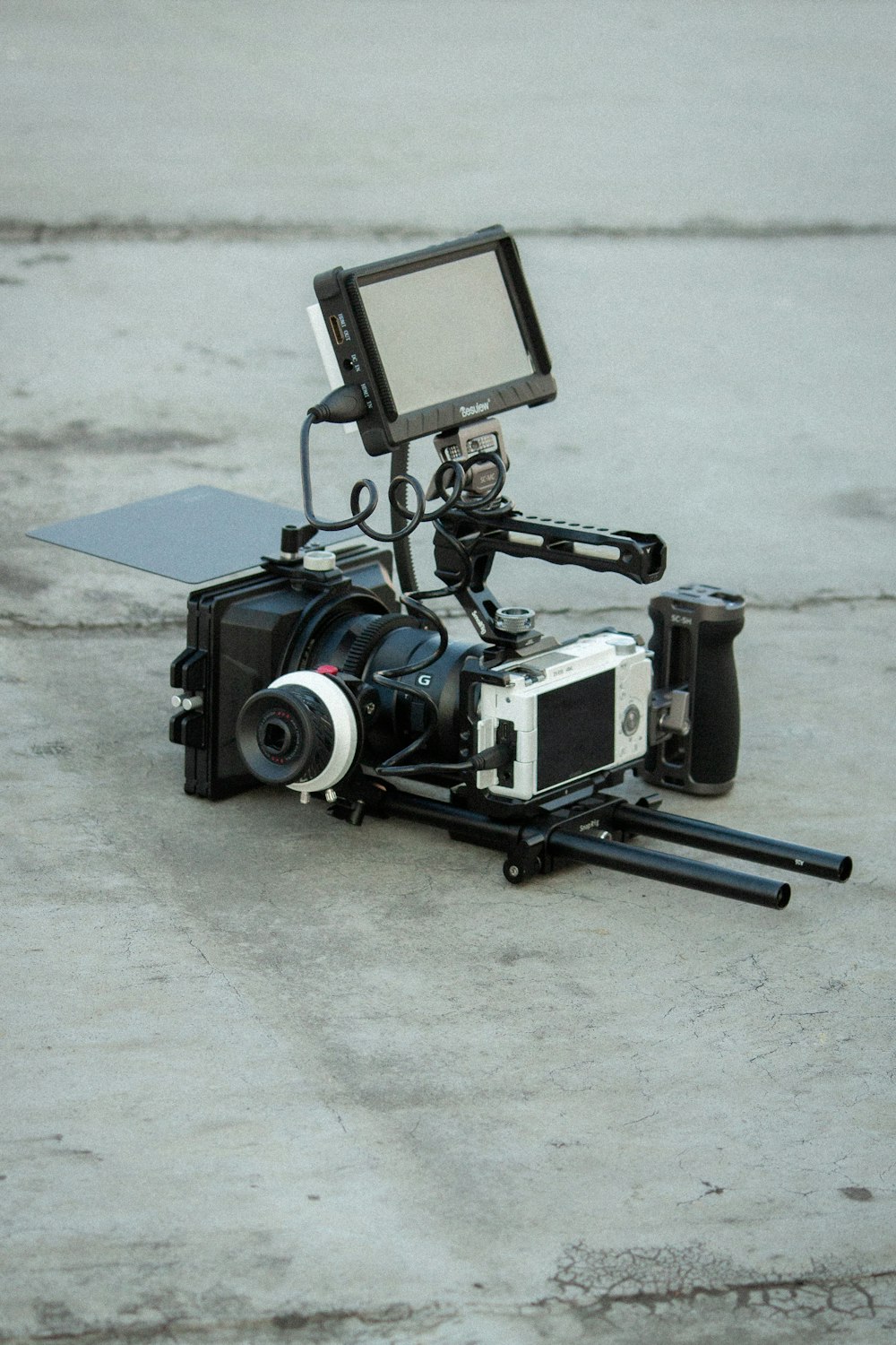 a video camera sitting on top of a cement floor