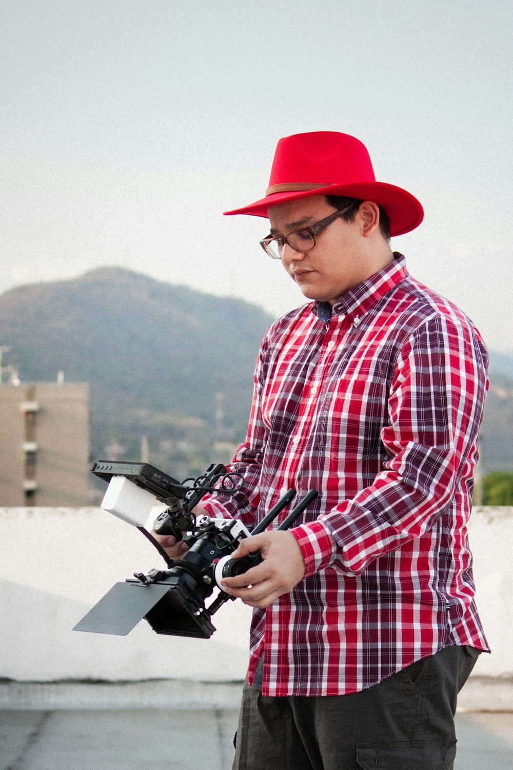 a man in a red hat holding a camera