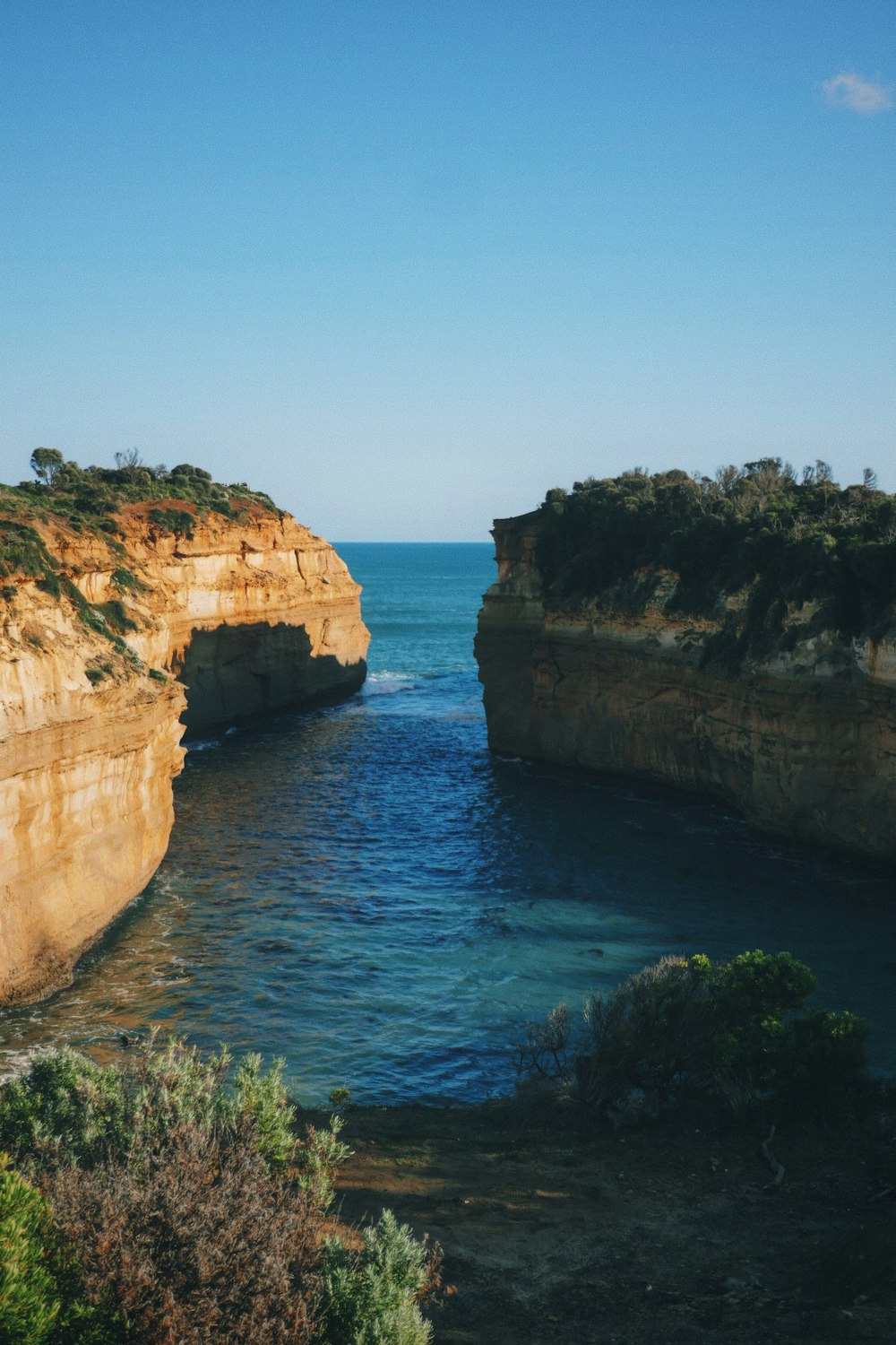 a large body of water near a rocky cliff