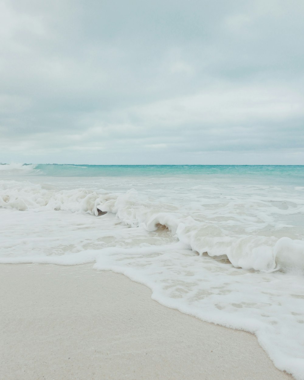 a beach with waves coming in and out of the water