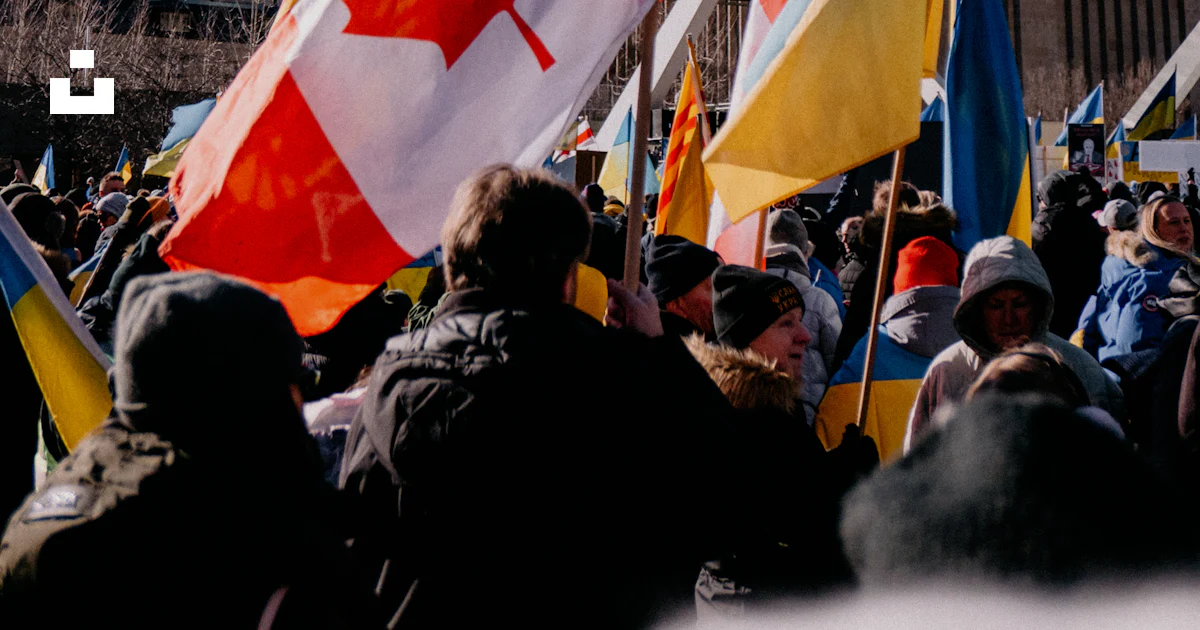 Current Events Canada Examples A crowd of people holding canadian and canadian flags photo – Free ...
