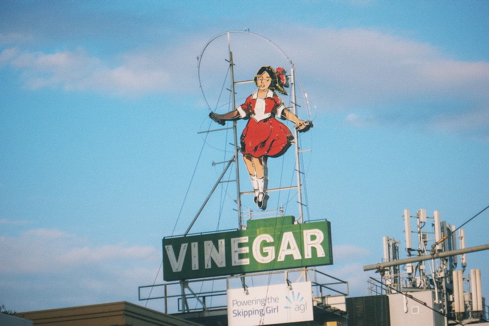 a woman in a red dress is hanging from a ferris wheel