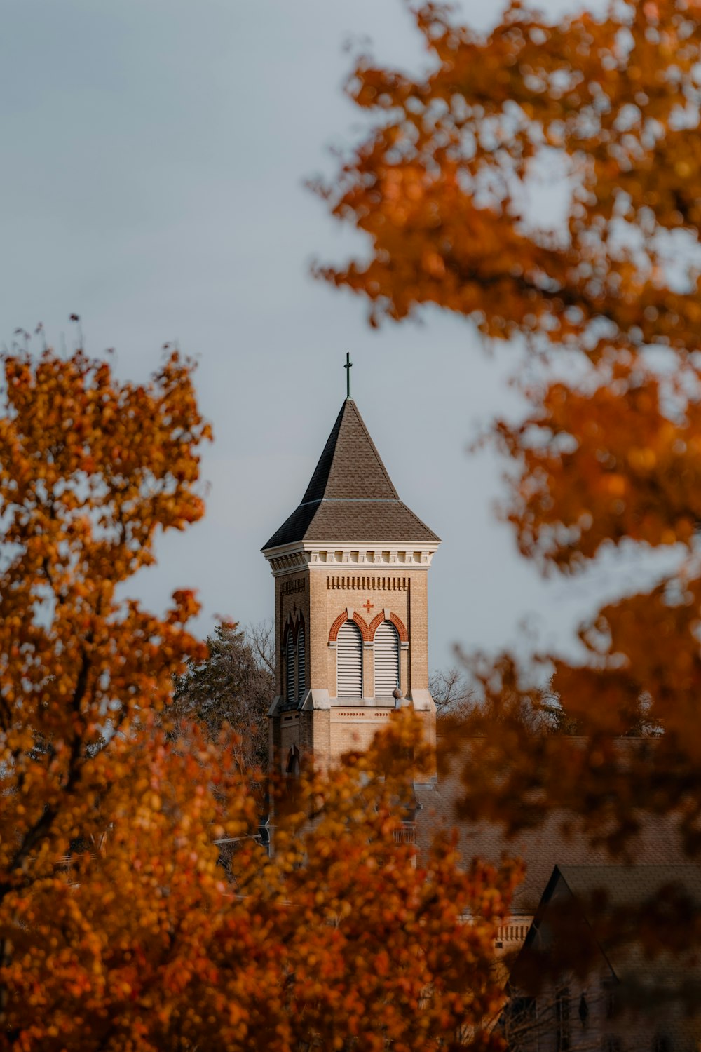 a tall tower with a cross on top of it