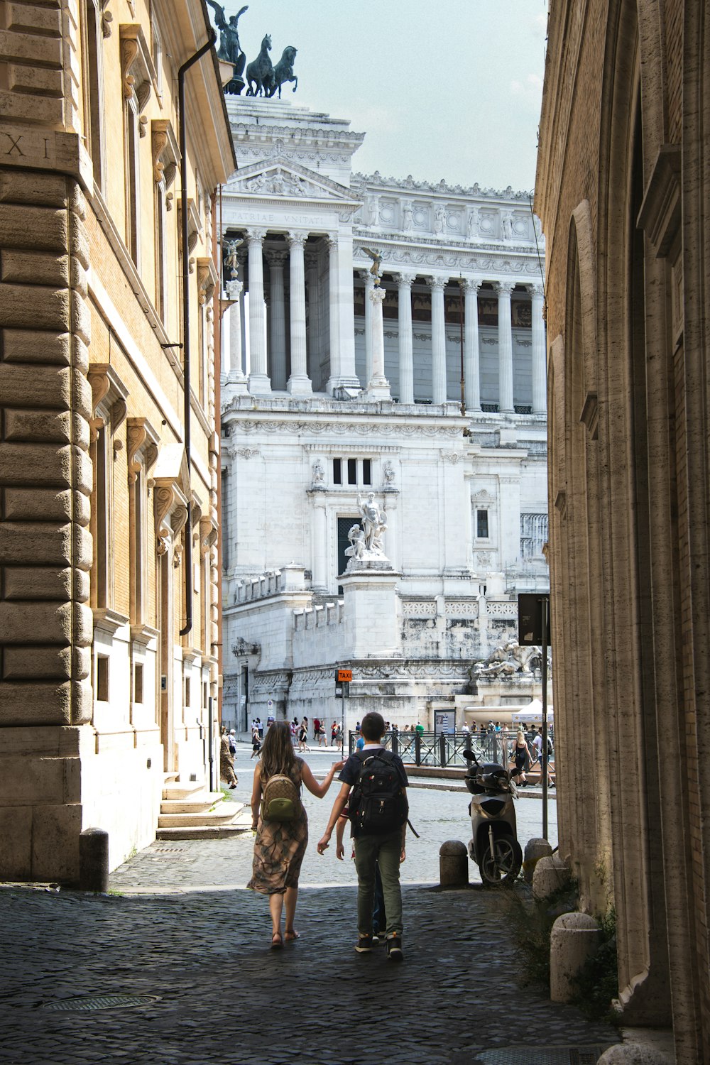 a couple of people walking down a street