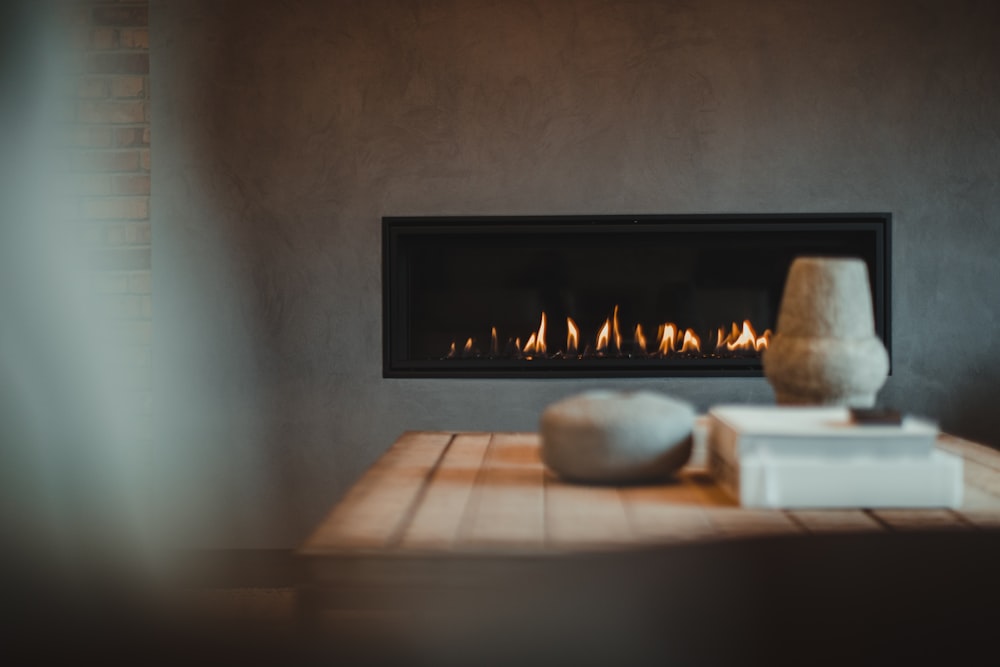 a table with a vase and a fire place on it