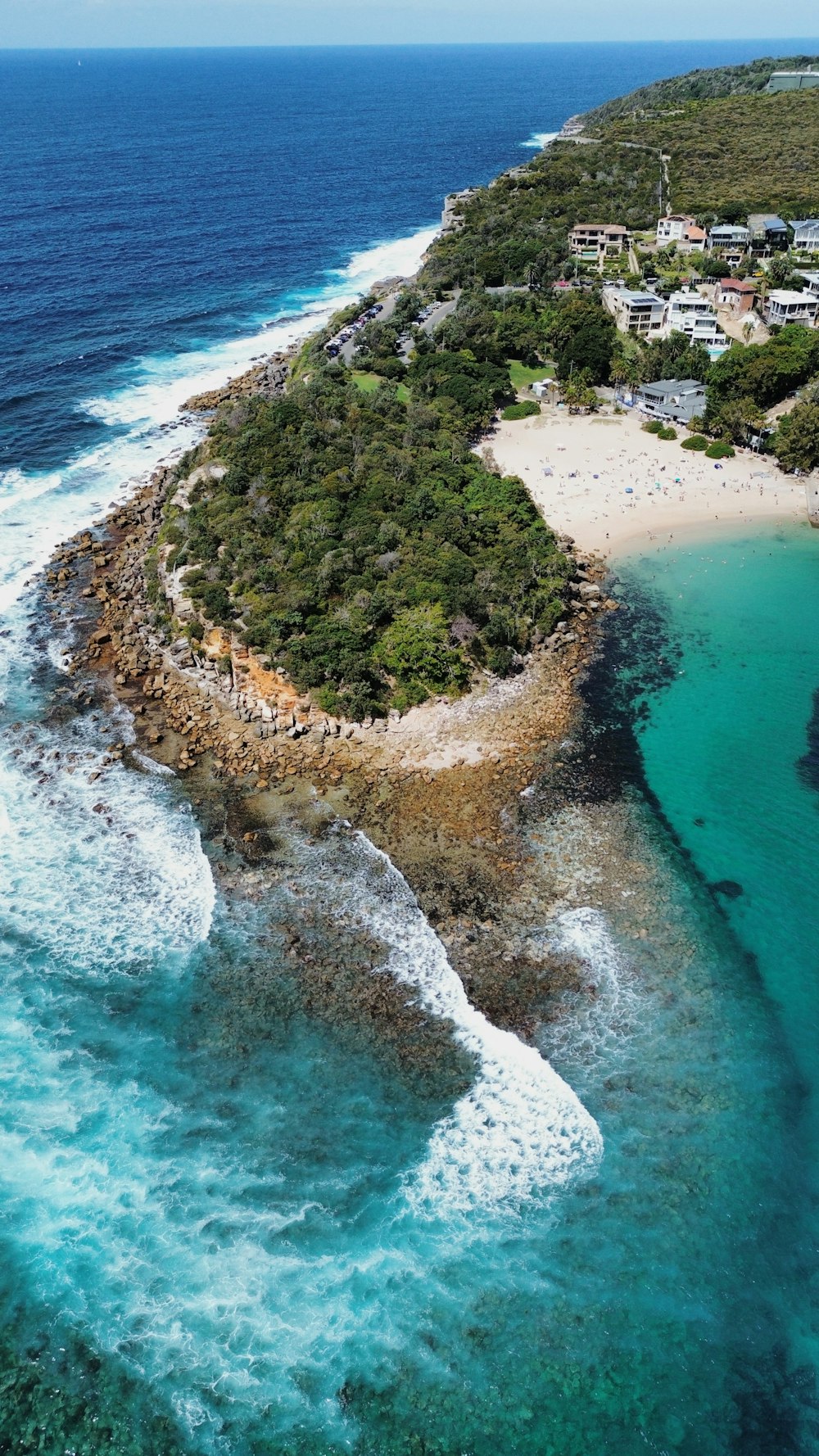 an aerial view of an island with a sandy beach
