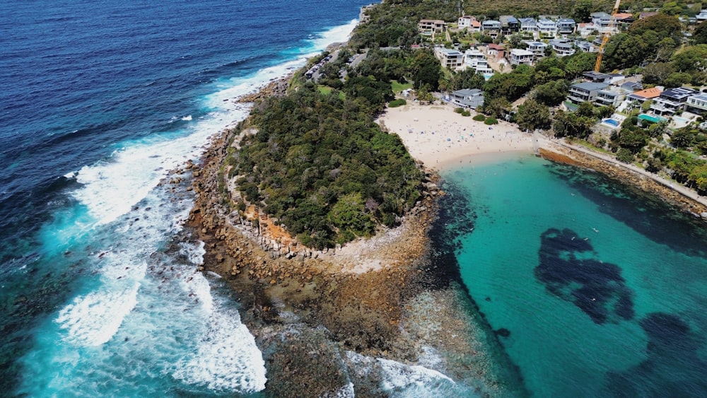 an aerial view of a small island with a sandy beach