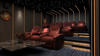 a room filled with red chairs and a table