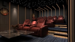 a room filled with red chairs and a table