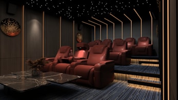 a room filled with red chairs and a table