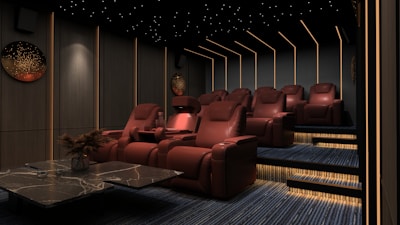 a room filled with red chairs and a table
