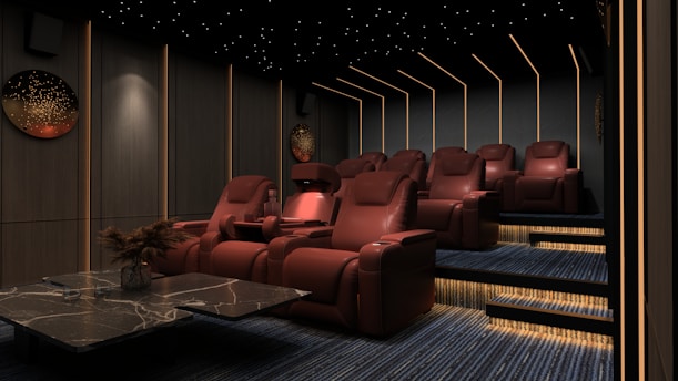 a room filled with red chairs and a table