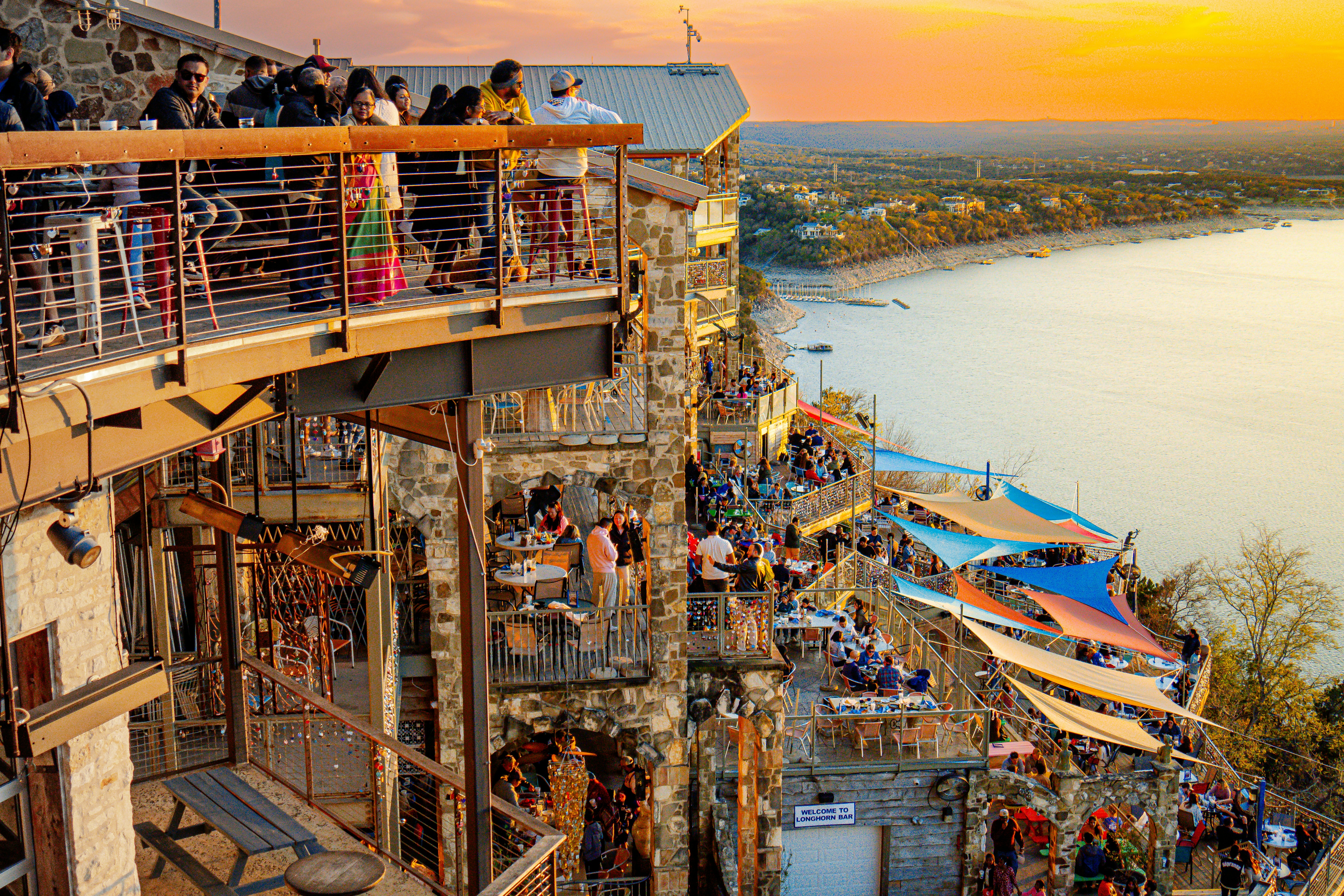a crowd of people standing on top of a tall building