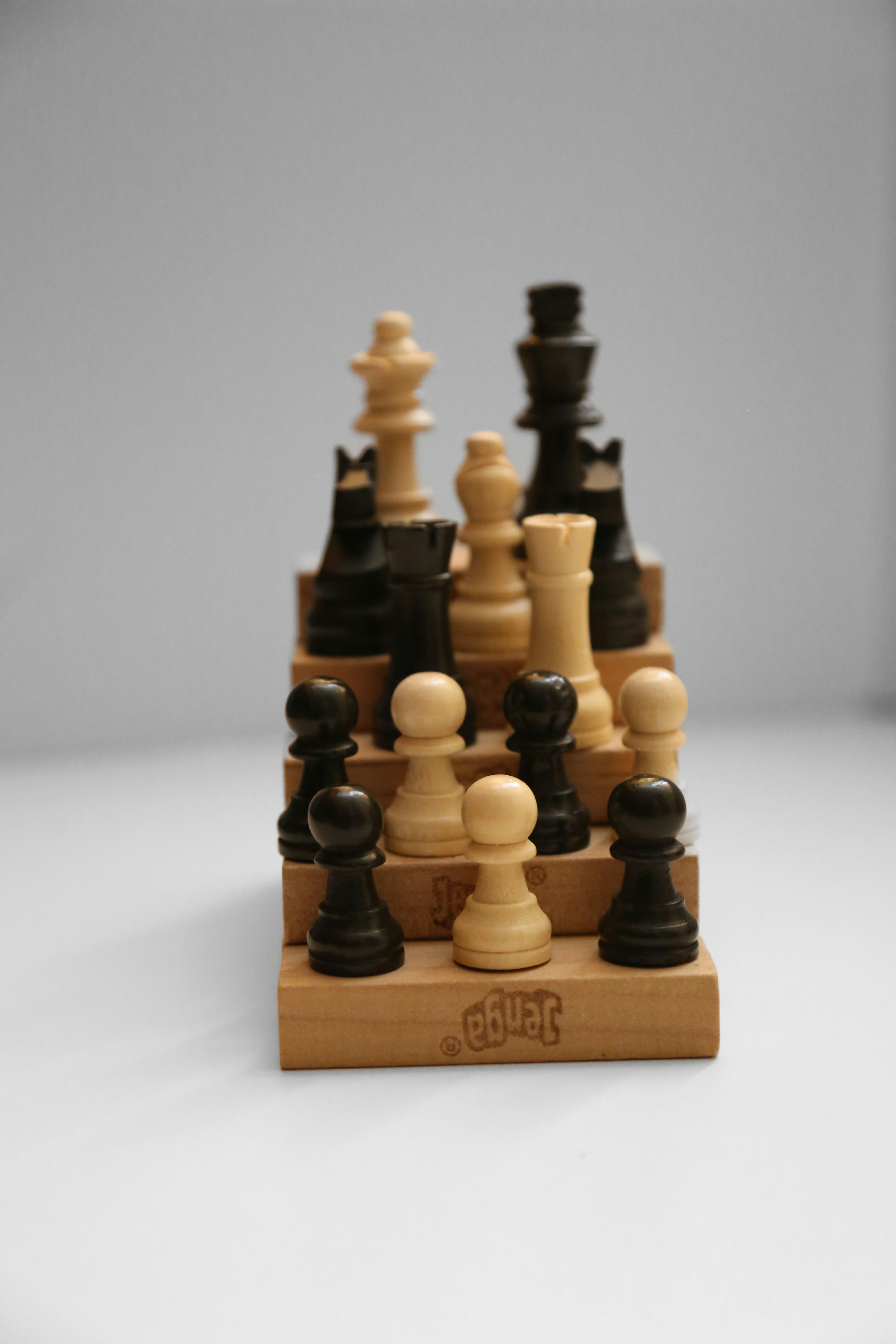 a wooden chess board with a chess set on top of it