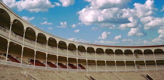 a large empty stadium with a sky background