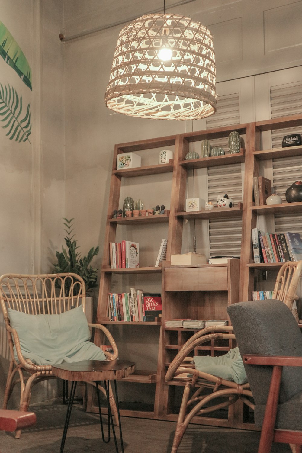 a living room with chairs and a book shelf