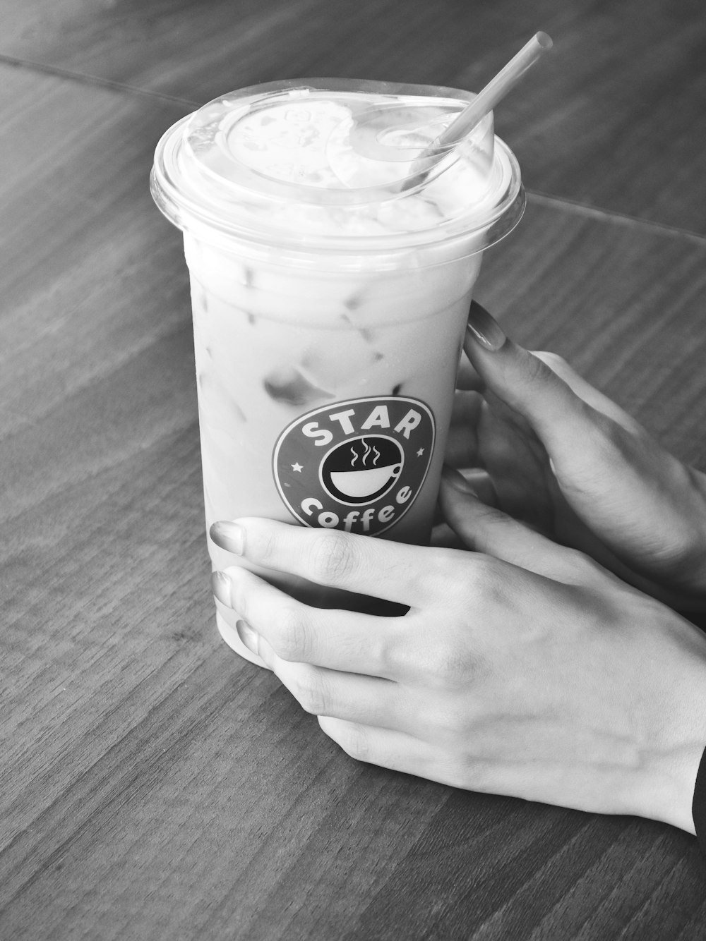 a person holding a cup of coffee on a table