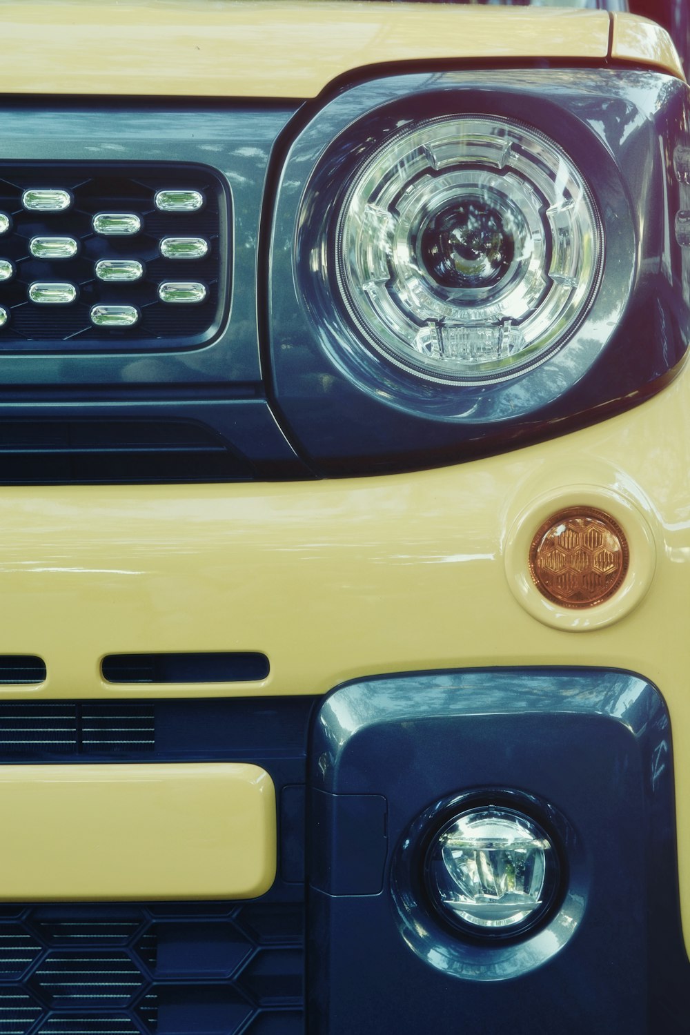 a close up of the front of a yellow vehicle