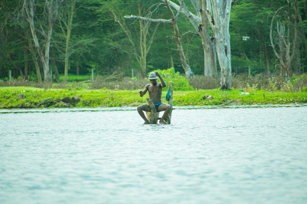 a man riding on the back of a wooden boat