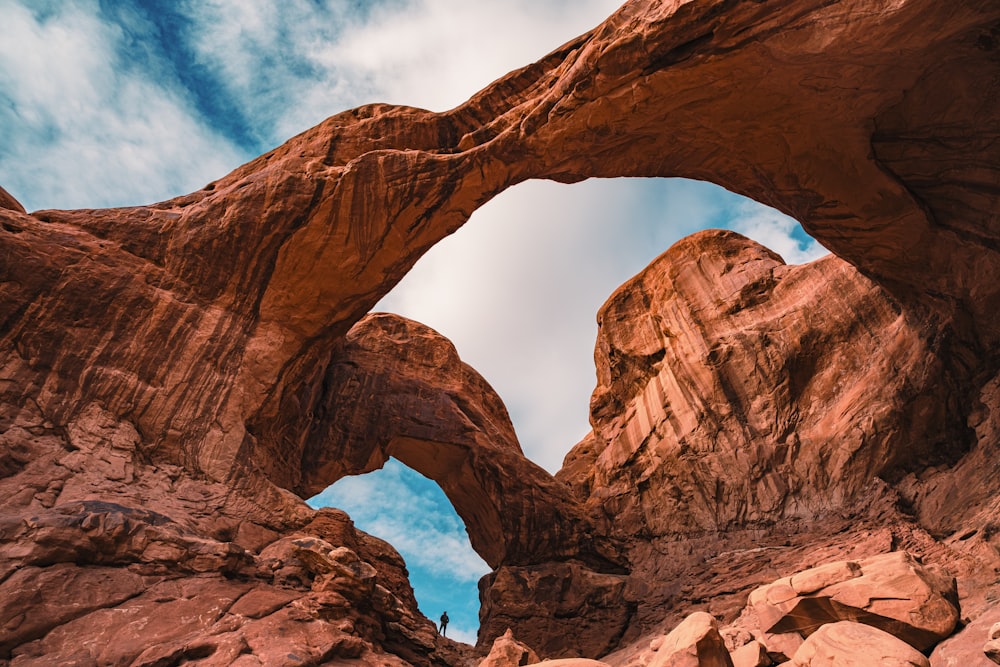 a large rock formation with a sky in the background