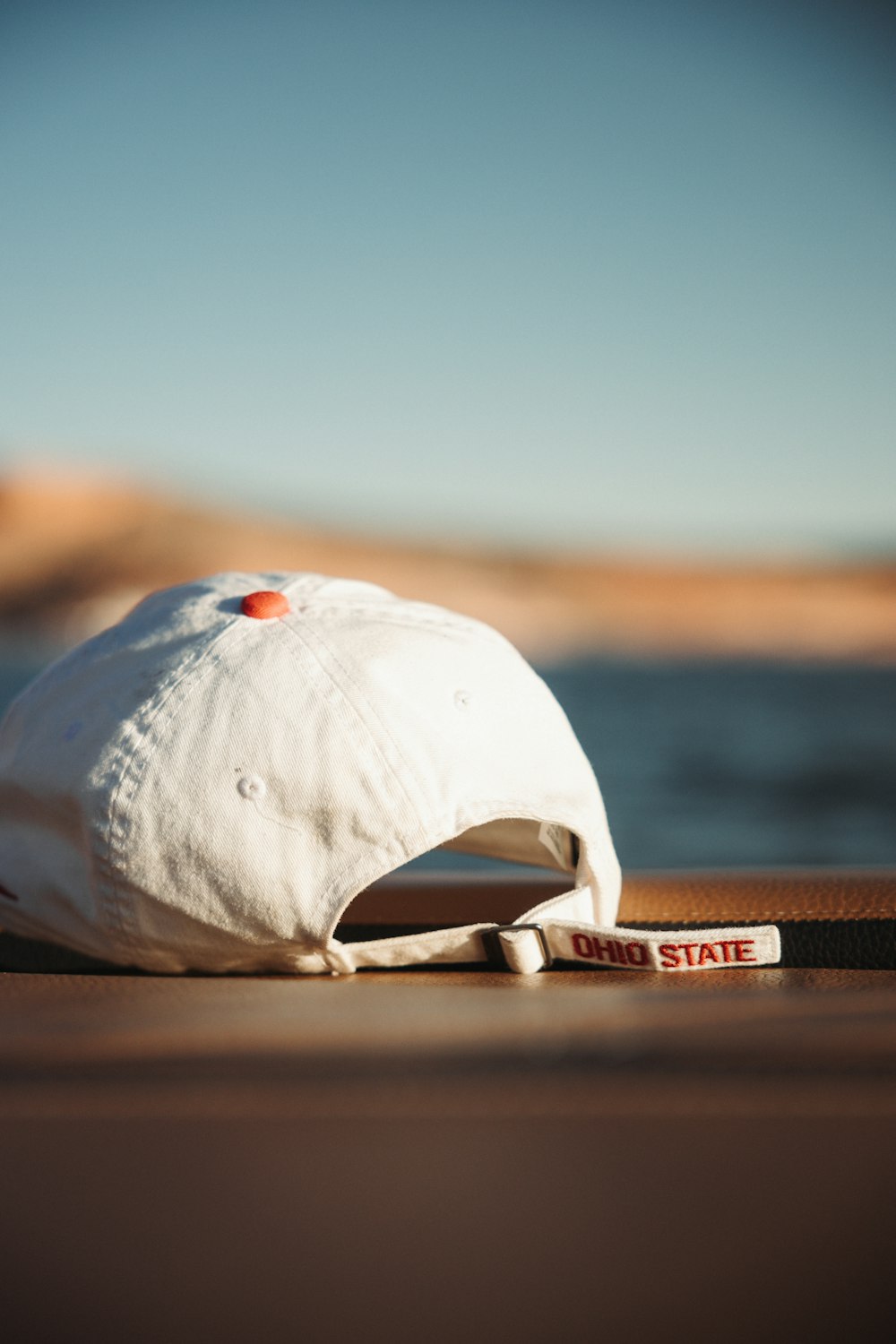 a white hat sitting on top of a wooden floor