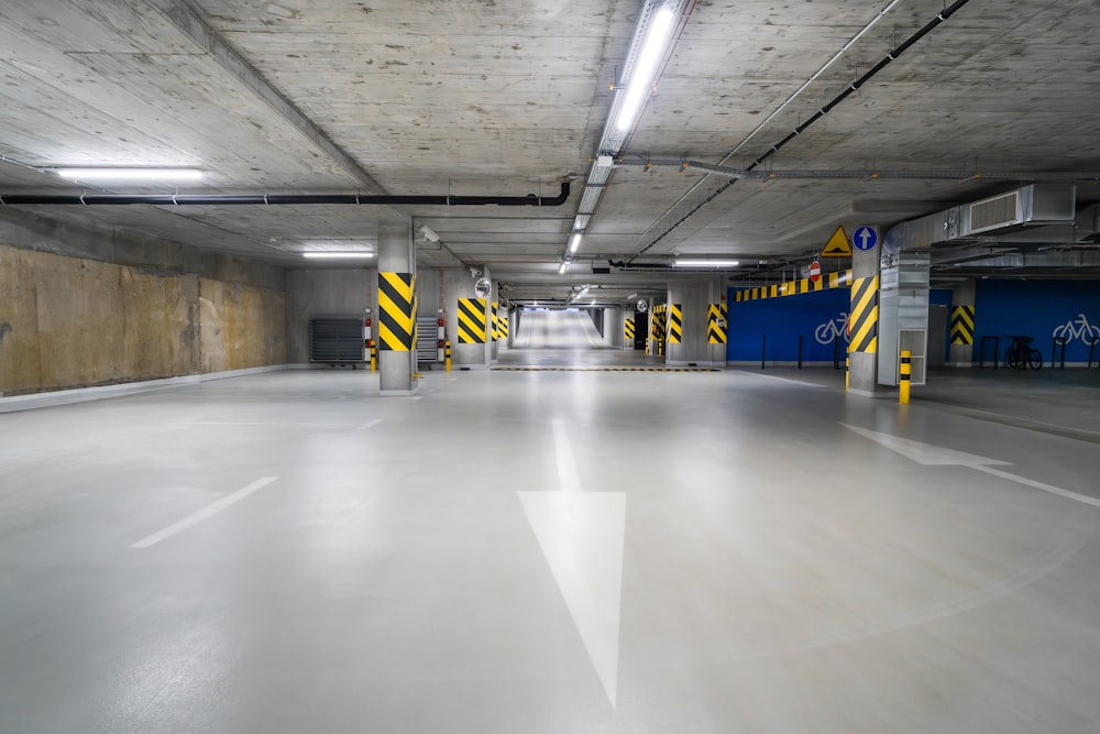 an empty parking garage with yellow and black stripes