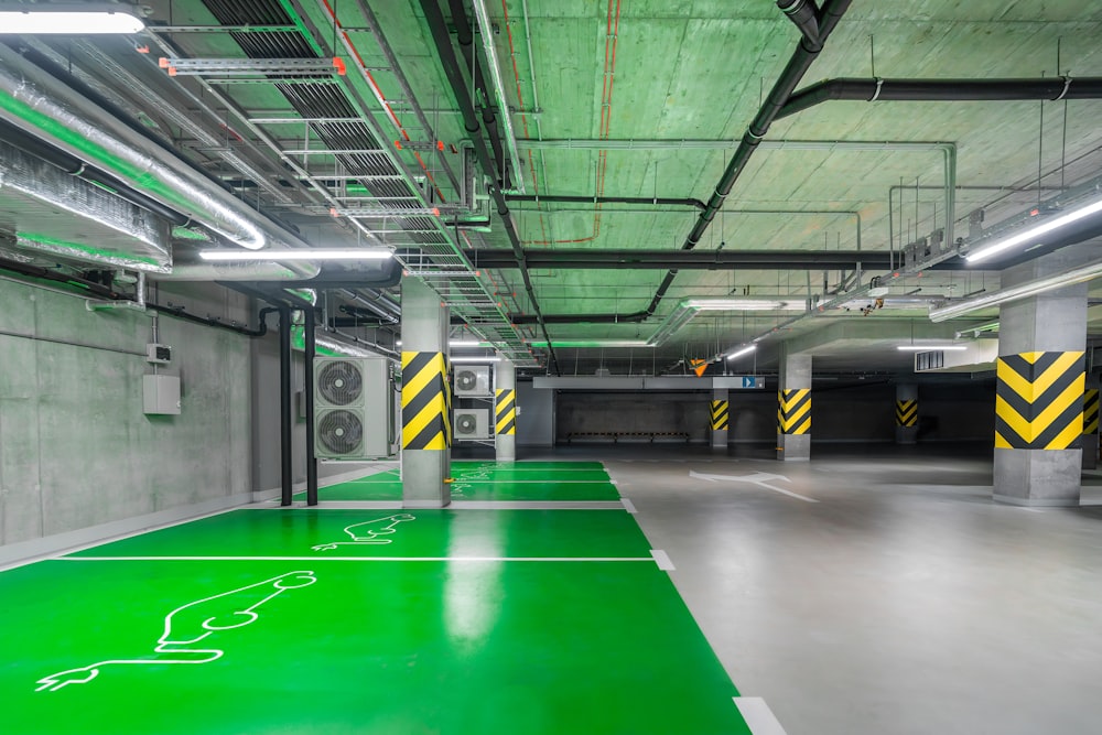 a parking garage with green and yellow lines on the floor