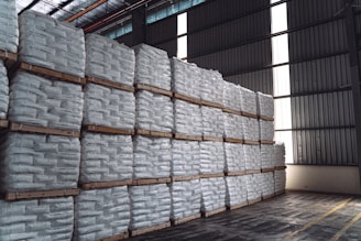 a warehouse filled with stacks of white bags