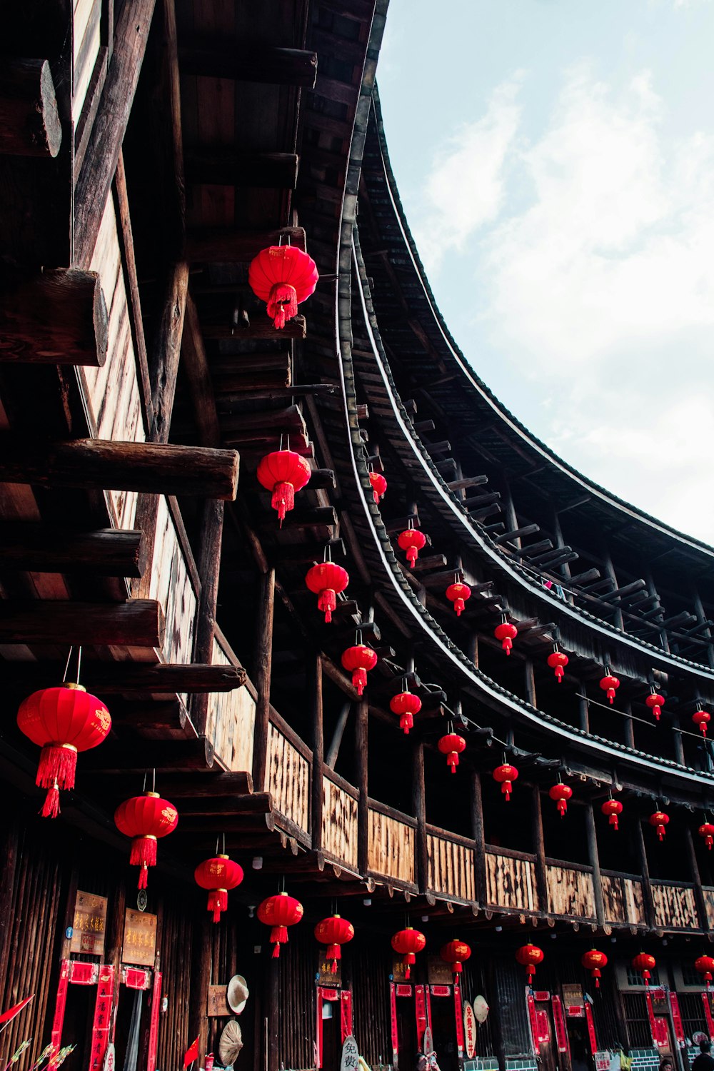 a building with red lanterns hanging from it's roof
