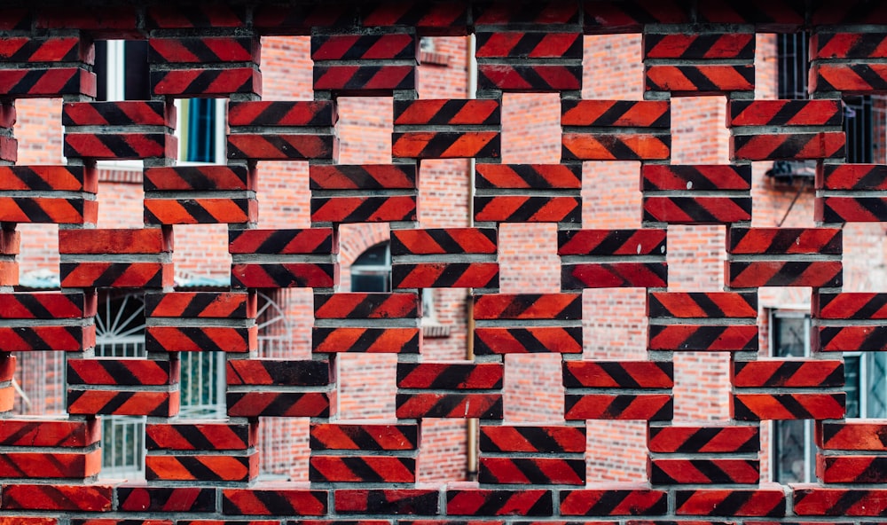 a red and black brick wall with several windows