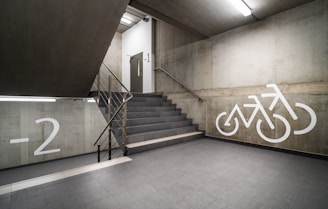 a staircase with a bicycle painted on the wall