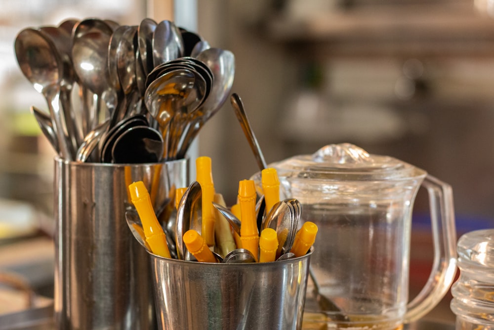 a metal cup with spoons and spoons in it