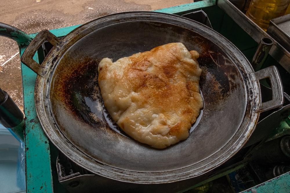 a frying pan filled with food on top of a stove