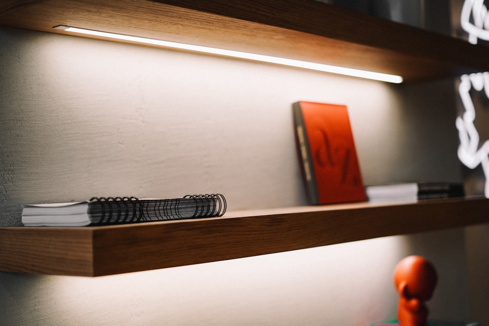 a wooden shelf with a book on top of it