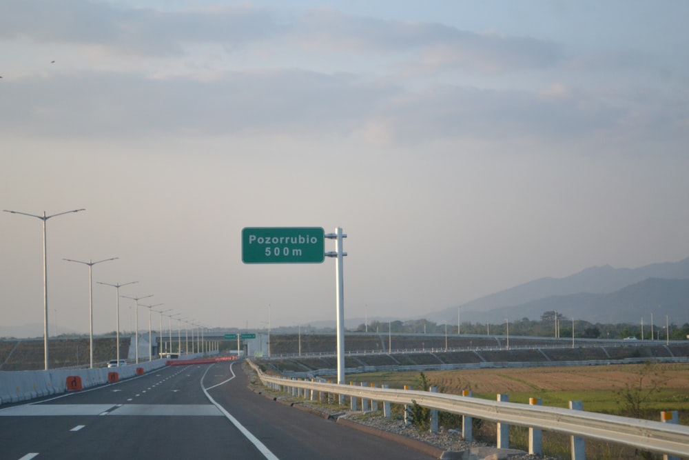 a highway with a road sign on the side of it