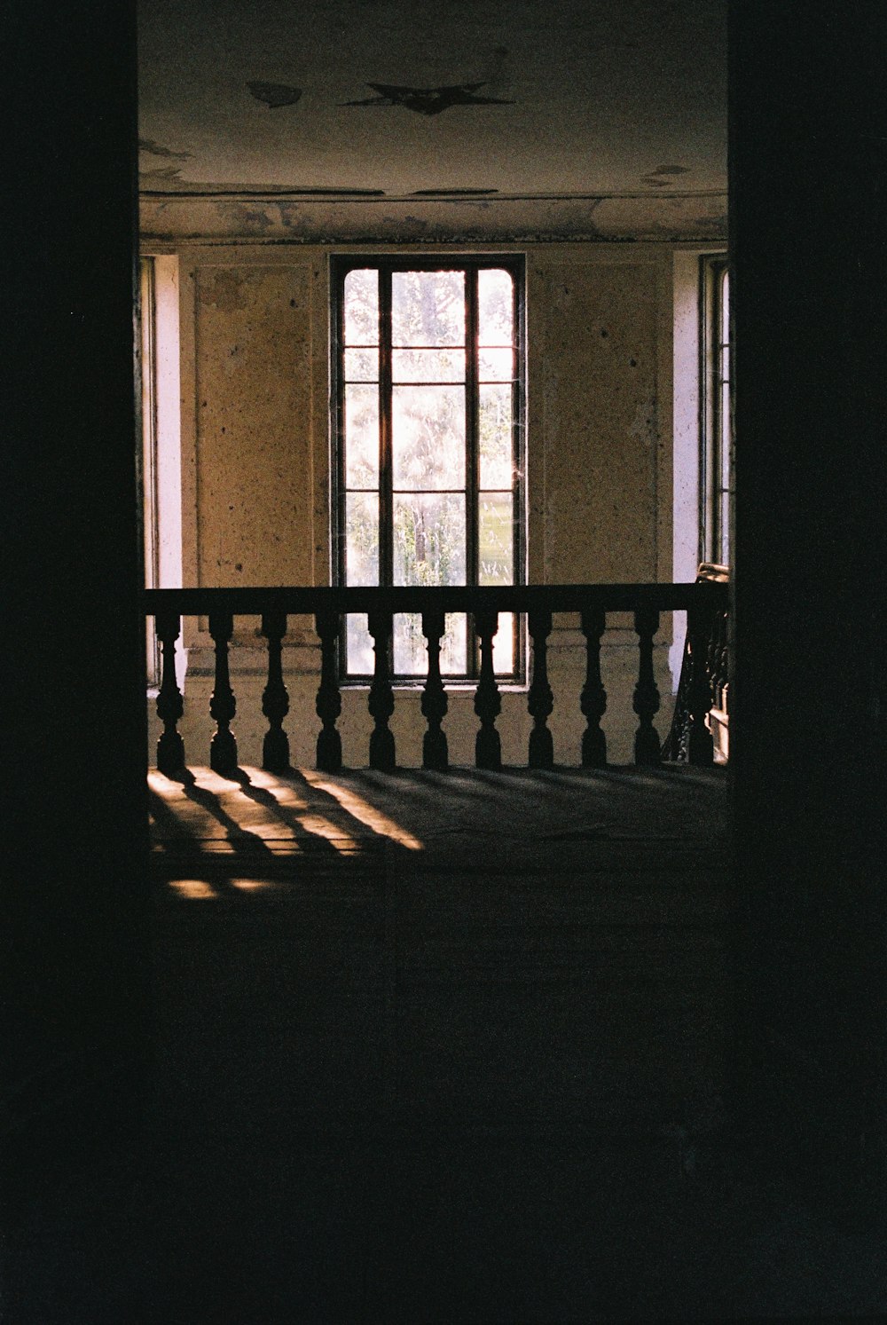 an empty room with a balcony and a window