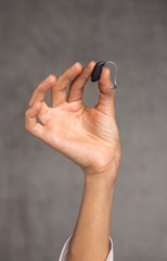 a hand holding an object in the air