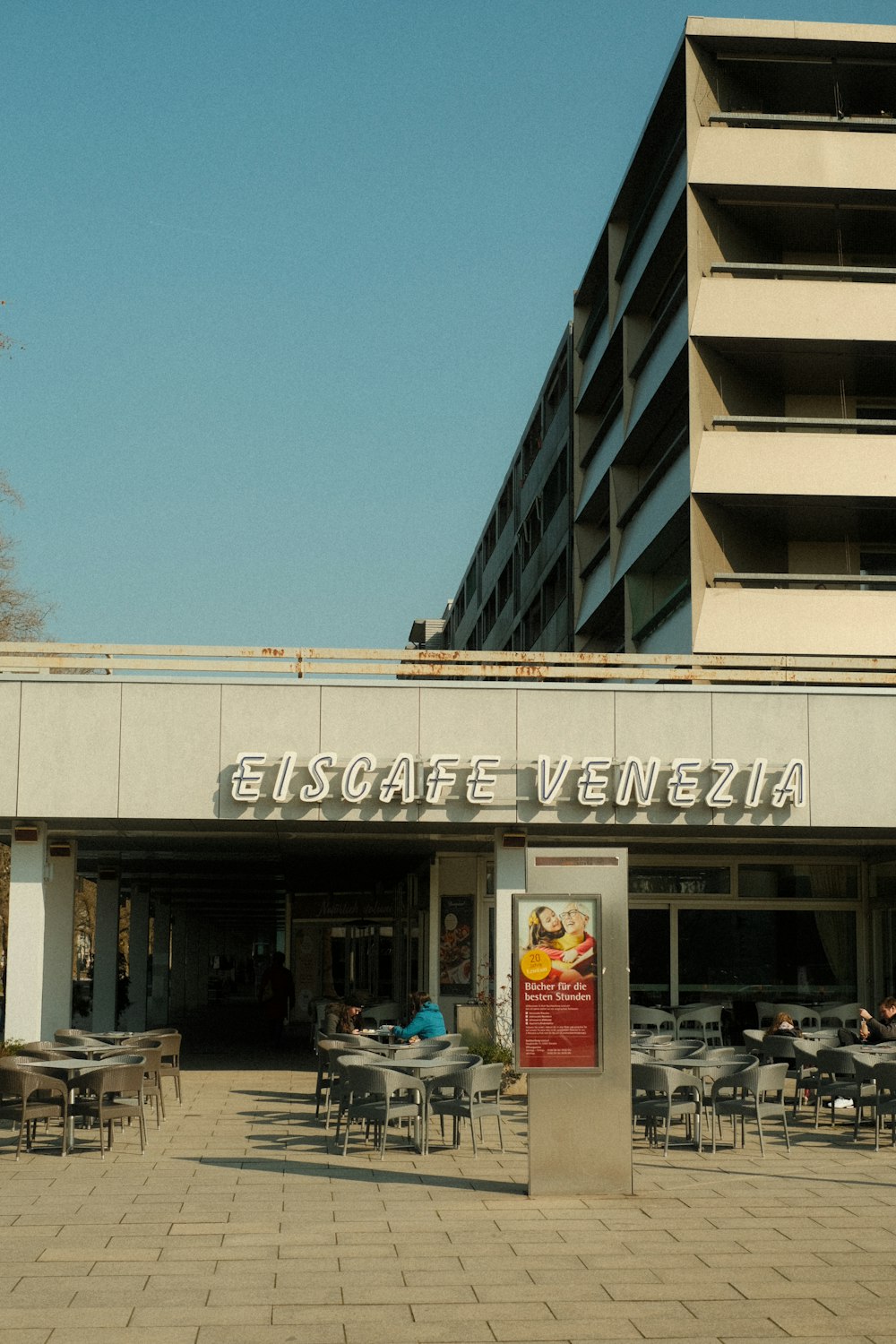 a restaurant with tables and chairs in front of a building