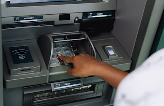 a person using an atm machine to pay money