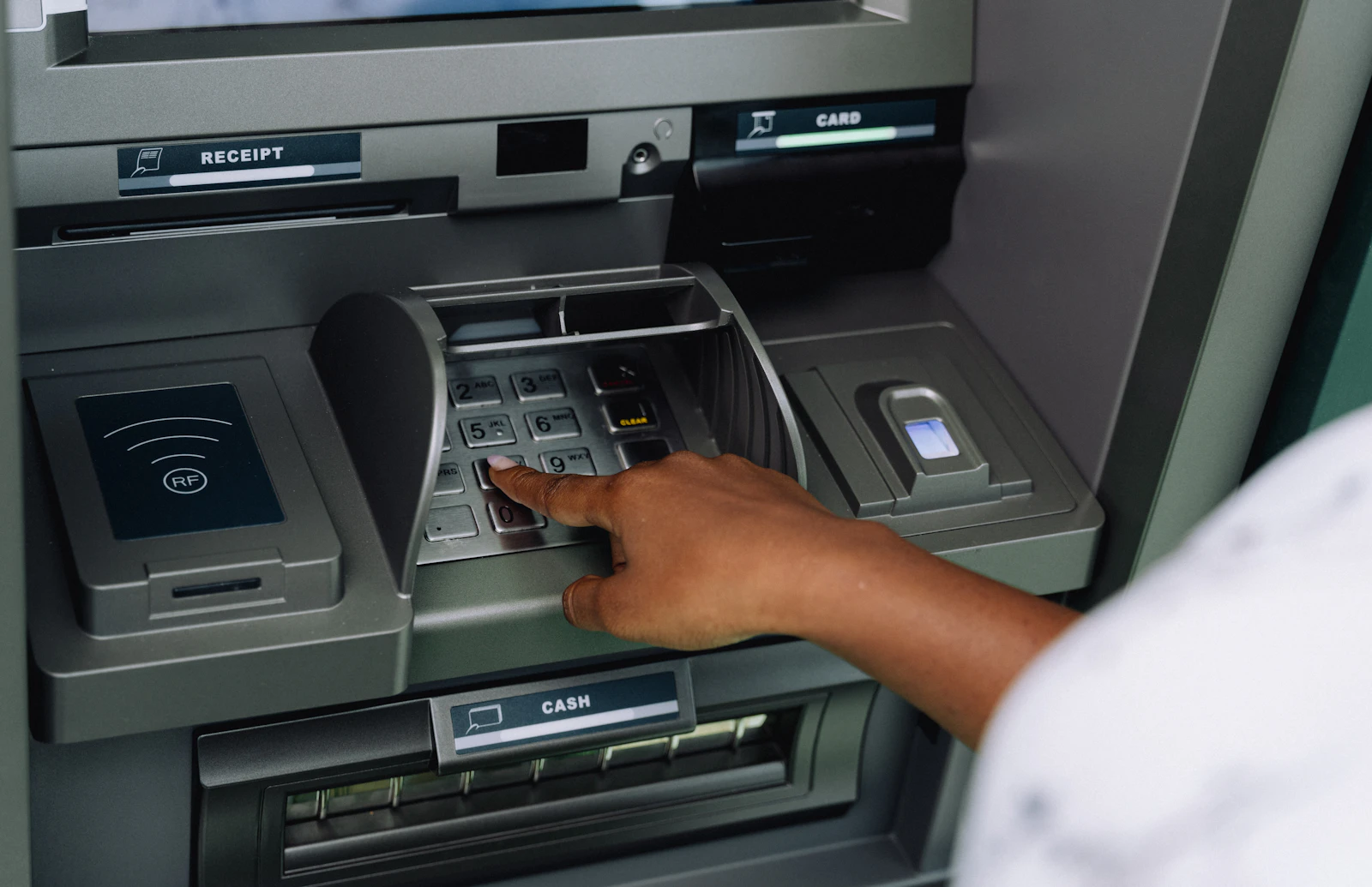 A person using an atm machine to pay money
