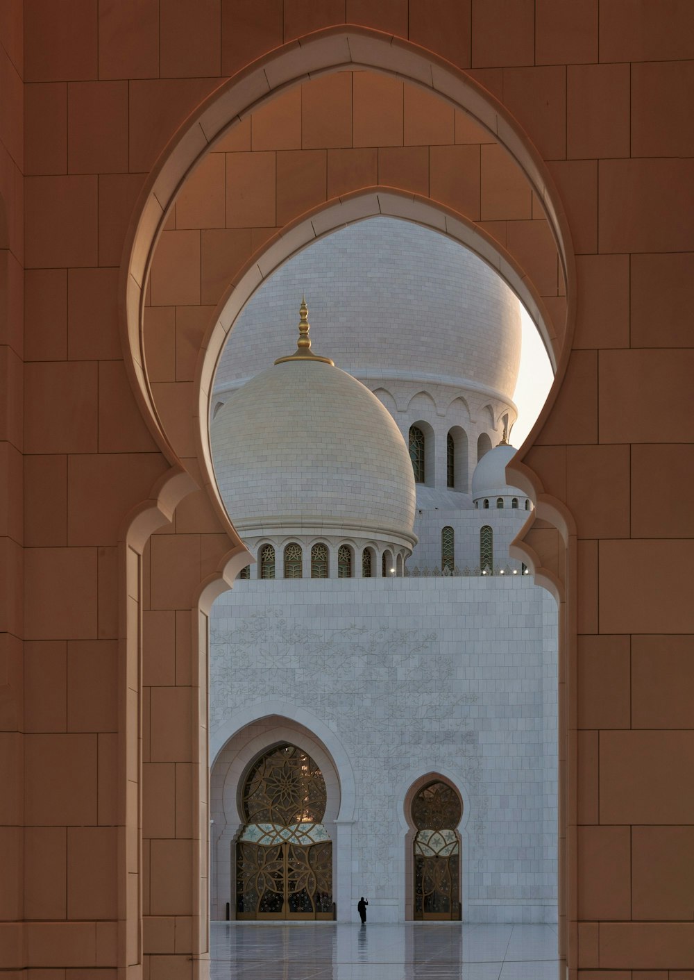 a large white building with arches and a dome