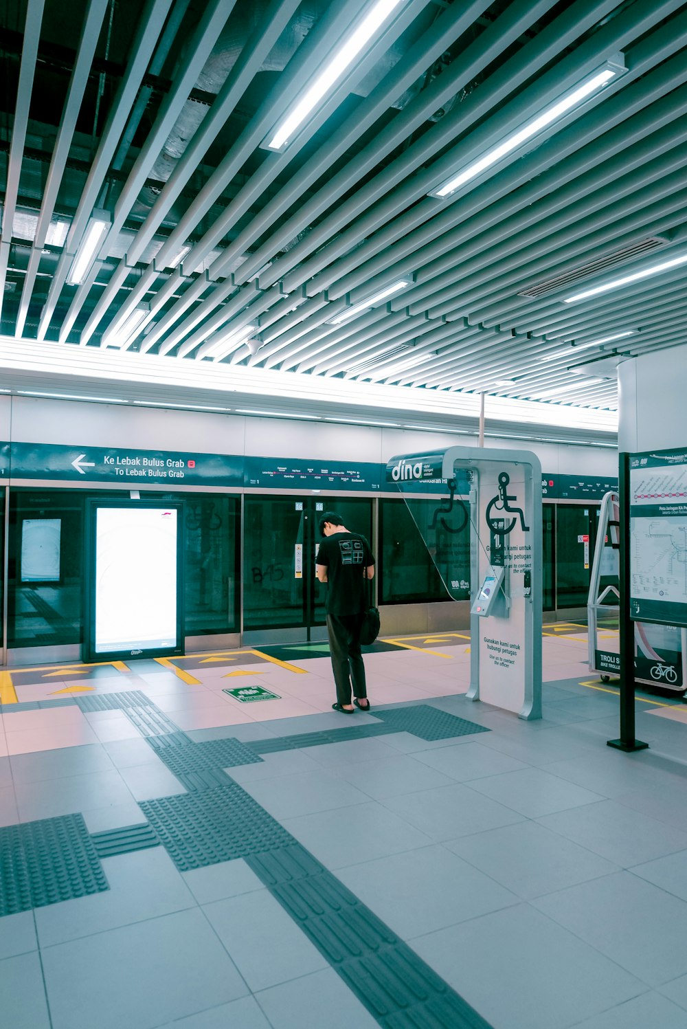 a man standing in a train station next to a train