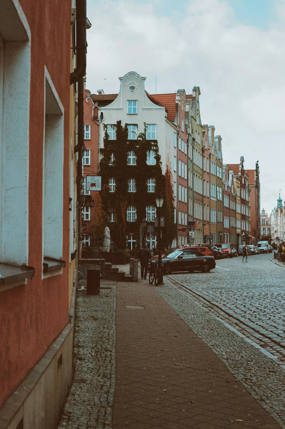 a cobblestone street lined with tall buildings