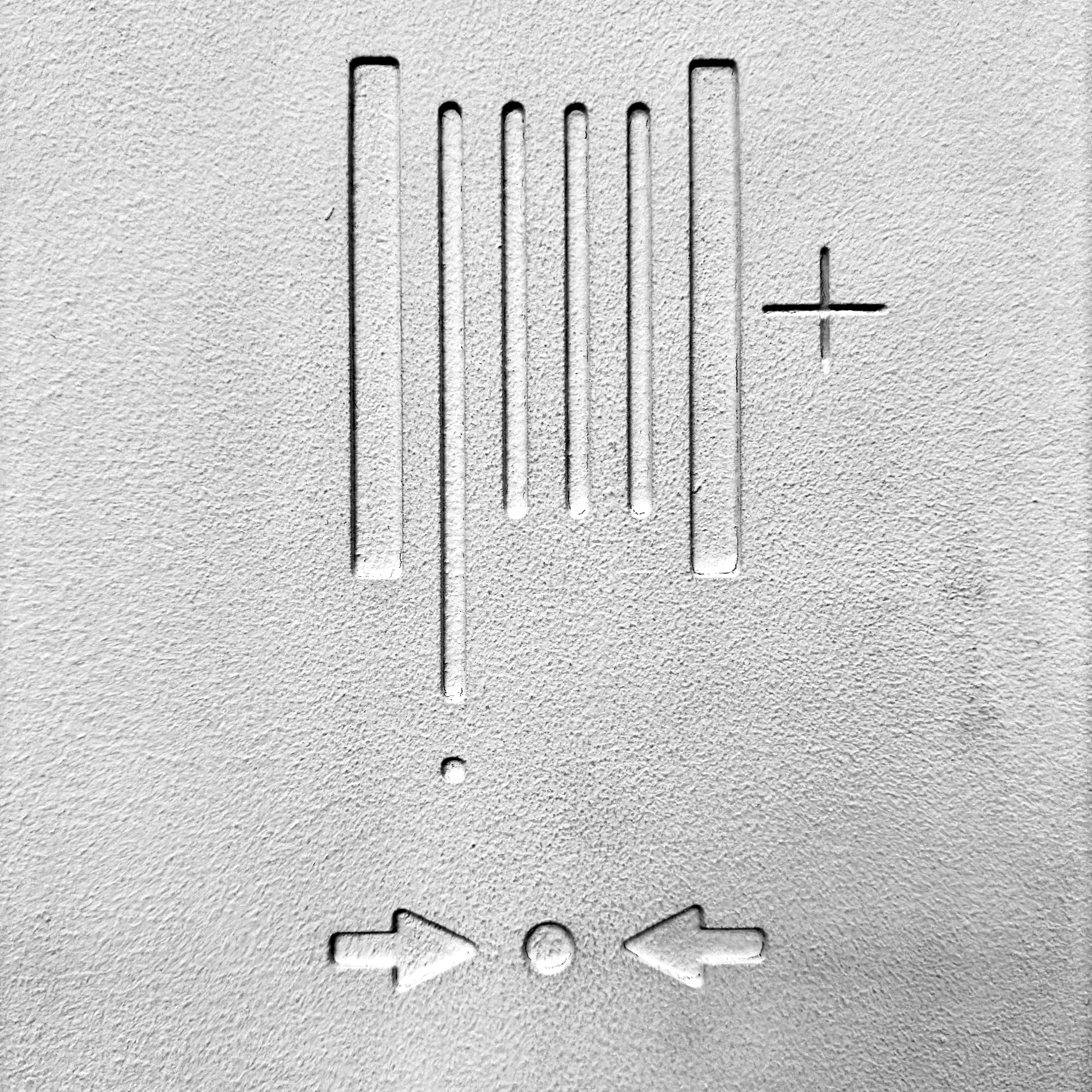 a close up of a metal object with two arrows