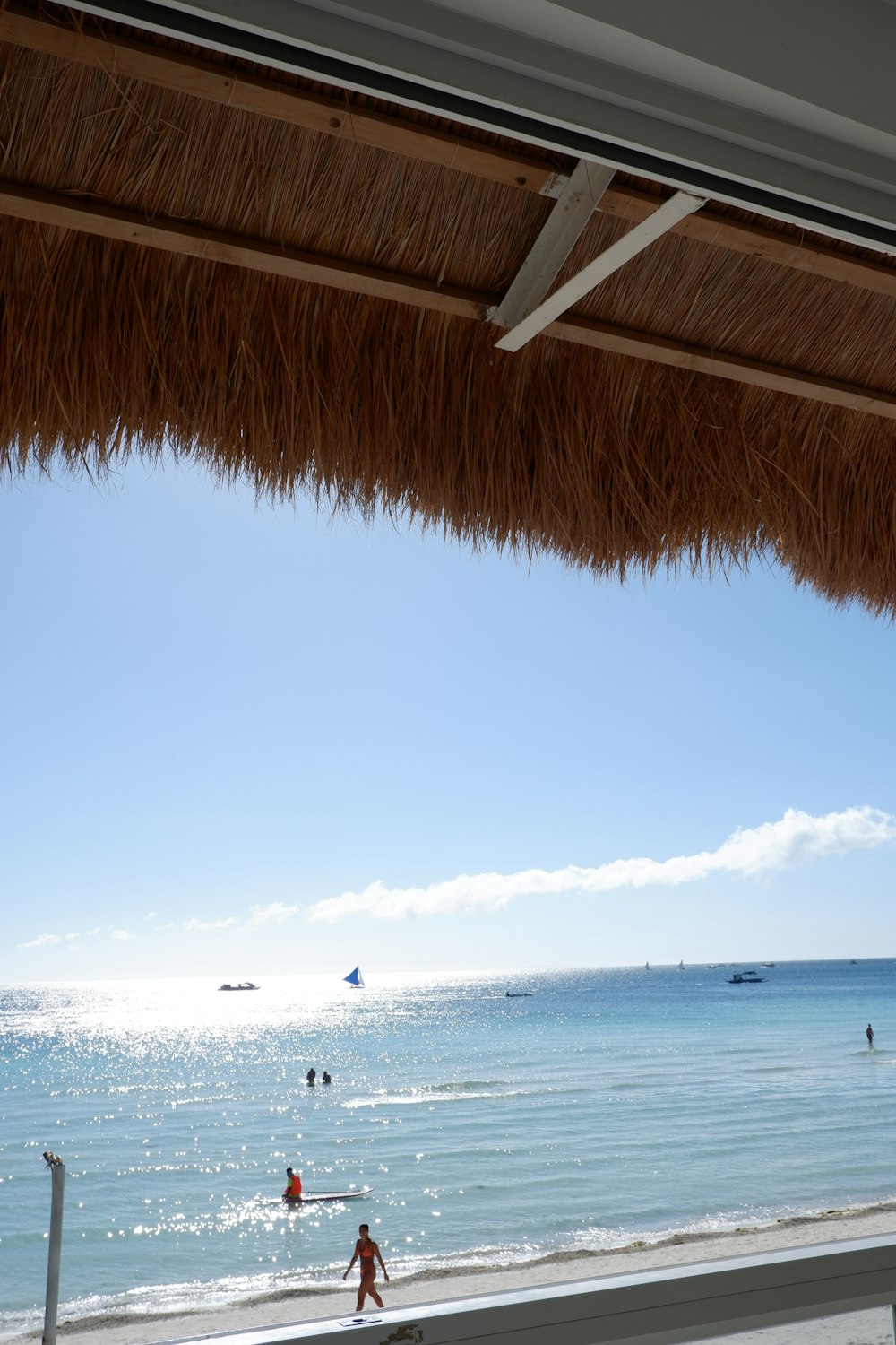 a view of a beach with people swimming in the water