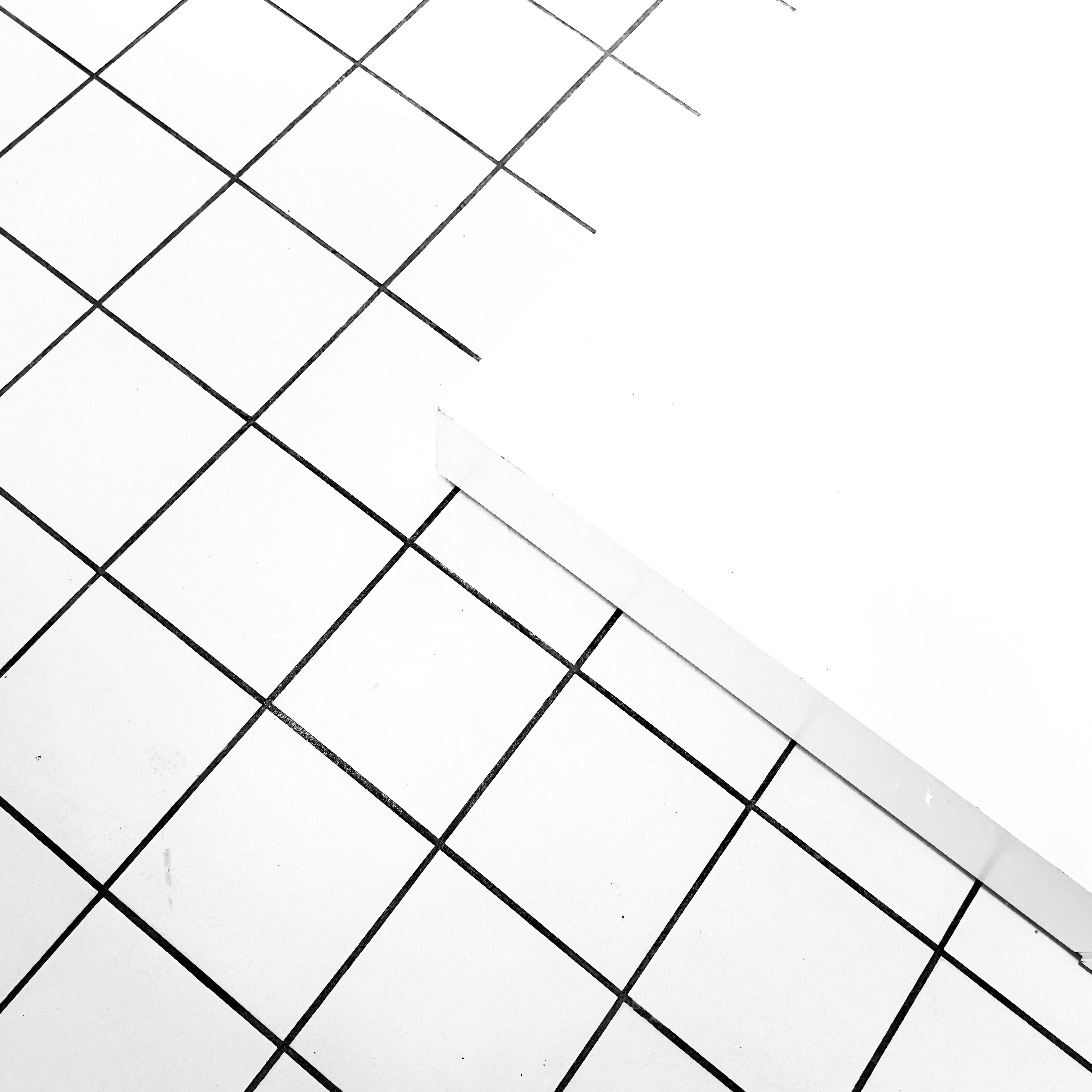 Digital watermark pattern overlay on bright white surface, geometric grid lines