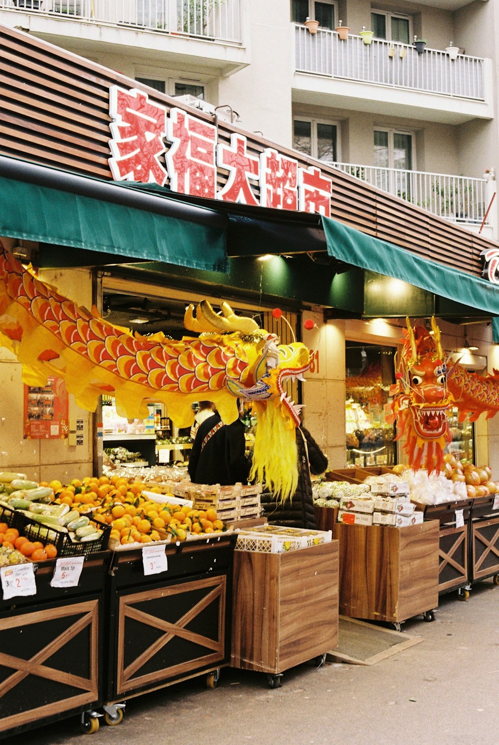 a store with a dragon statue on the front of it