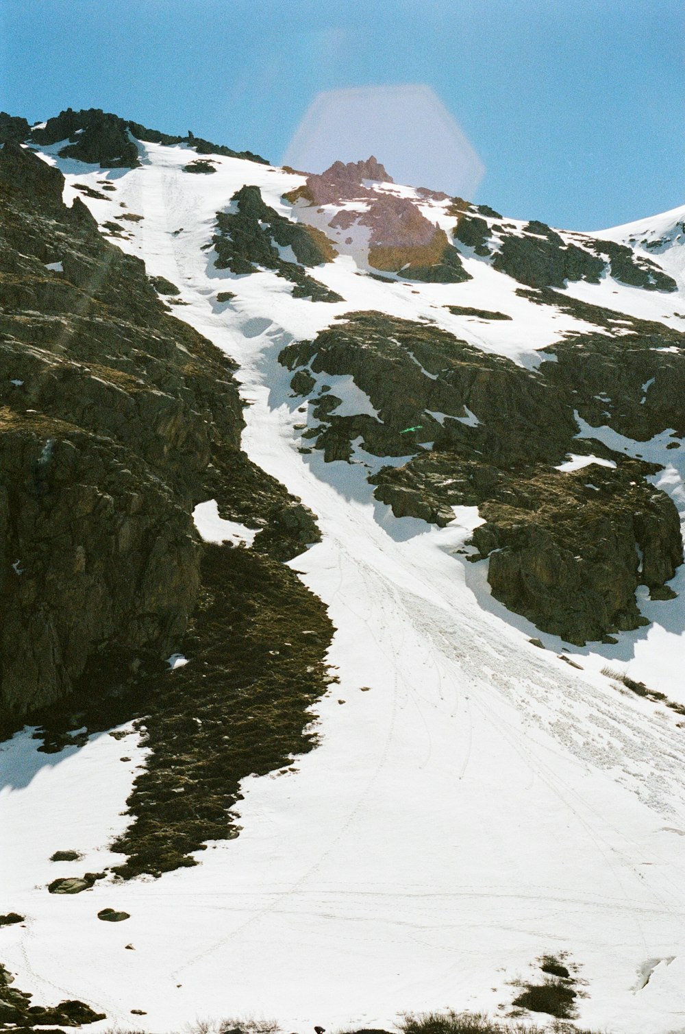 a man riding skis down a snow covered slope