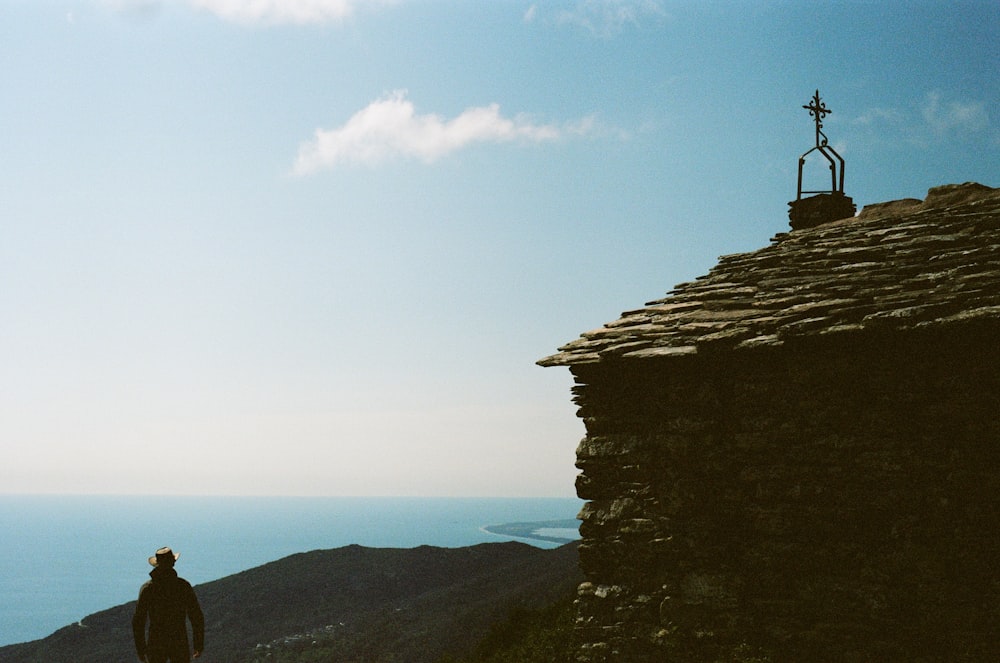 a man standing at the top of a mountain