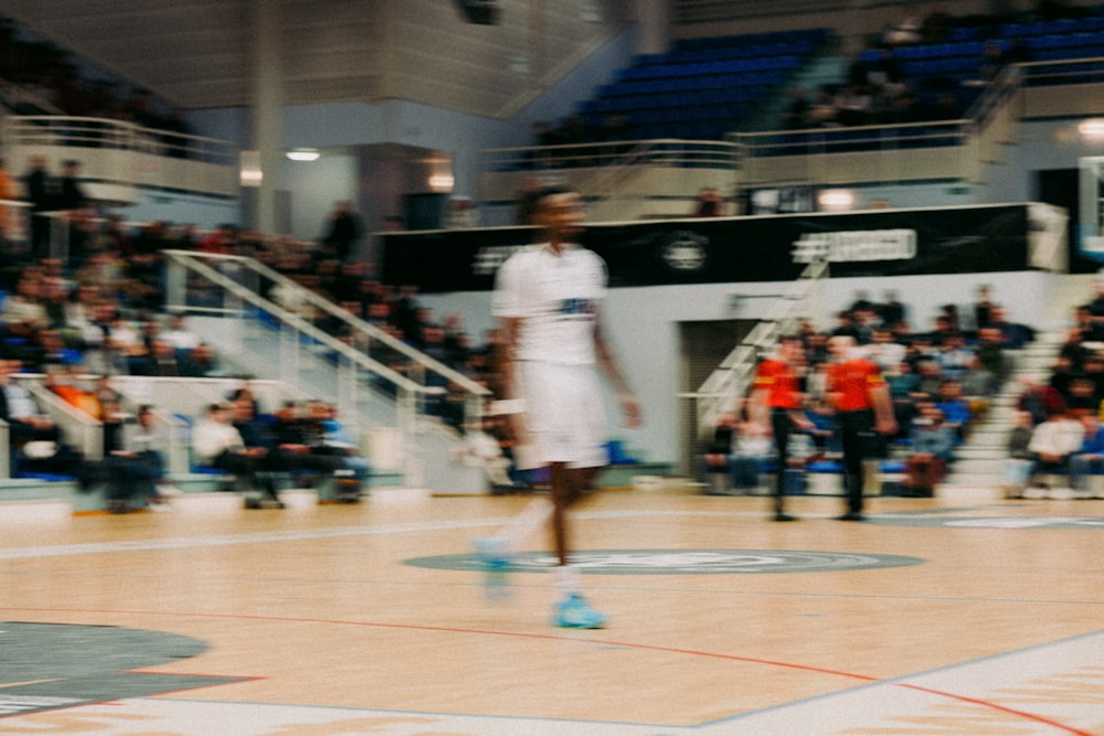 a man standing on top of a basketball court